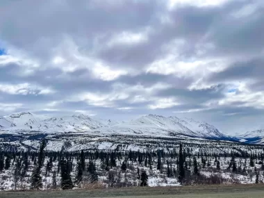 View of the snow-covered mountains from the road in Alaska