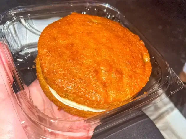 A carrot cake cookie sandwich with frosting in side from the cafe at Hollywood Studios, Disney World
