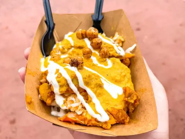 Korma Chicken covered in yellow curry and chickpeas from India Pavilion in Epcot, Disney World