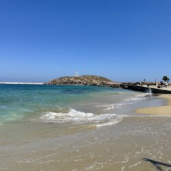 A beach in Naxos Town with Apollo's Temple in the background