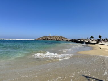 A beach in Naxos Town with Apollo's Temple in the background