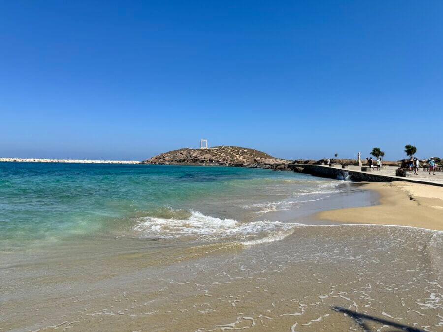 A beach in Naxos Town with Apollo's Temple in the background