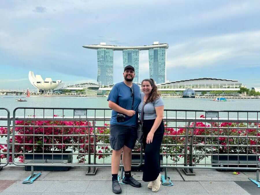 Zac and Elaina standing in front of the Marina Bay in Singapore with Marina Bay Sands in the background