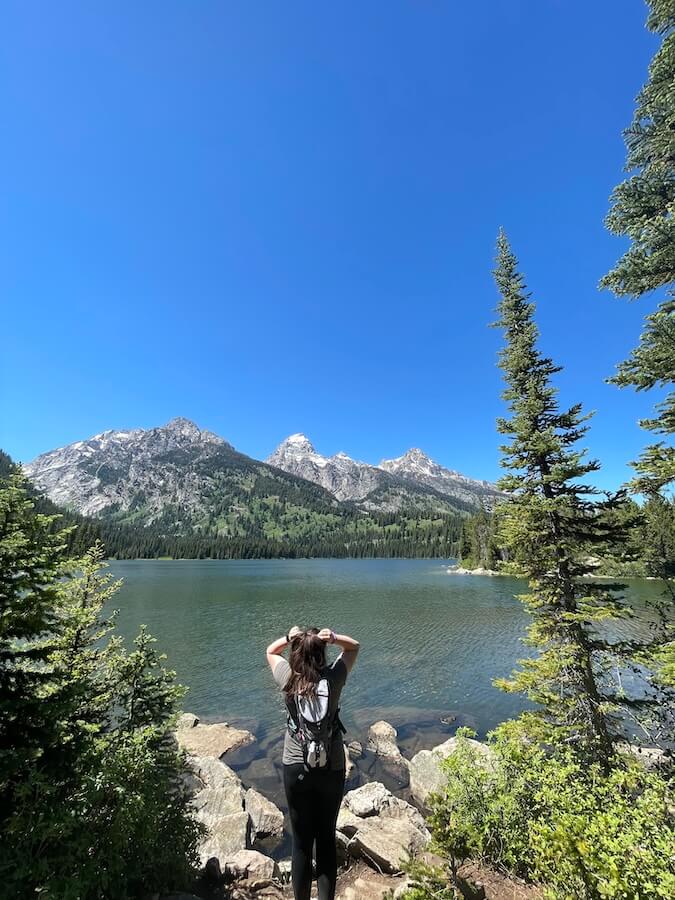 Elaina looking out over a lake during a hike through a national park