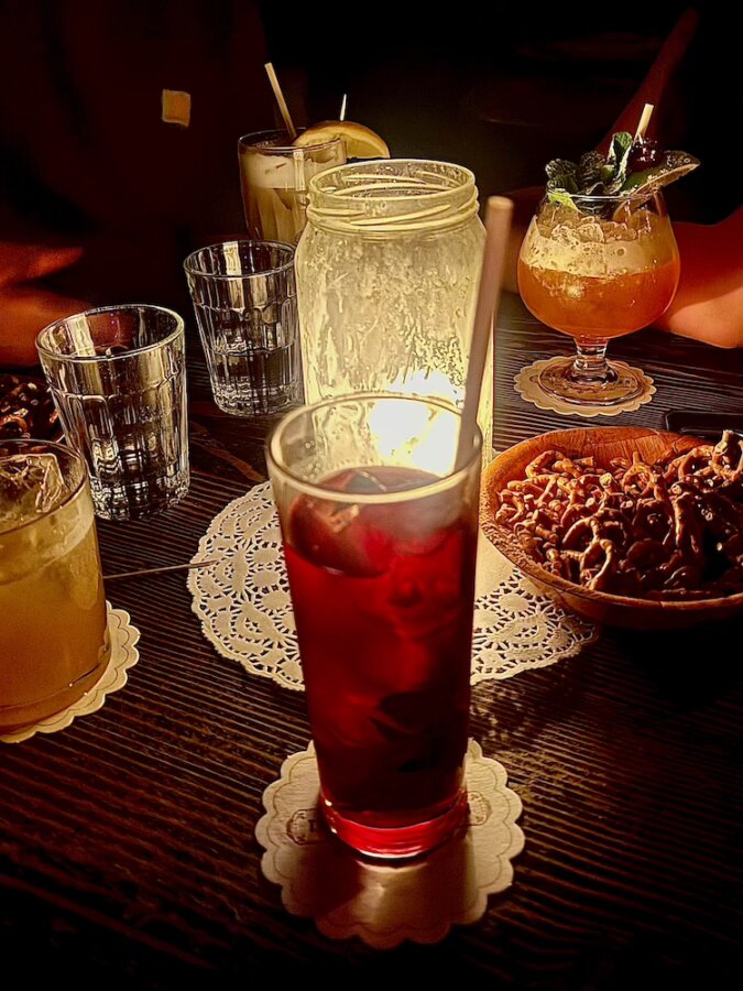 Drinks and a candle on a table at Baxter Inn cocktail bar in Sydney
