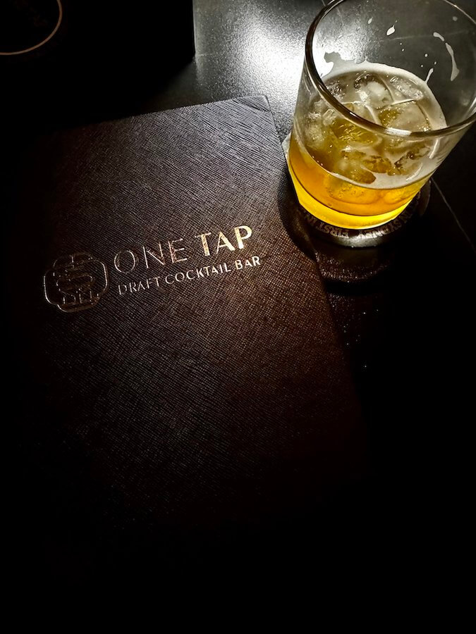 a cocktail and the menu laying on the table at One Tap Bar in Sydney during a cocktail bar crawl