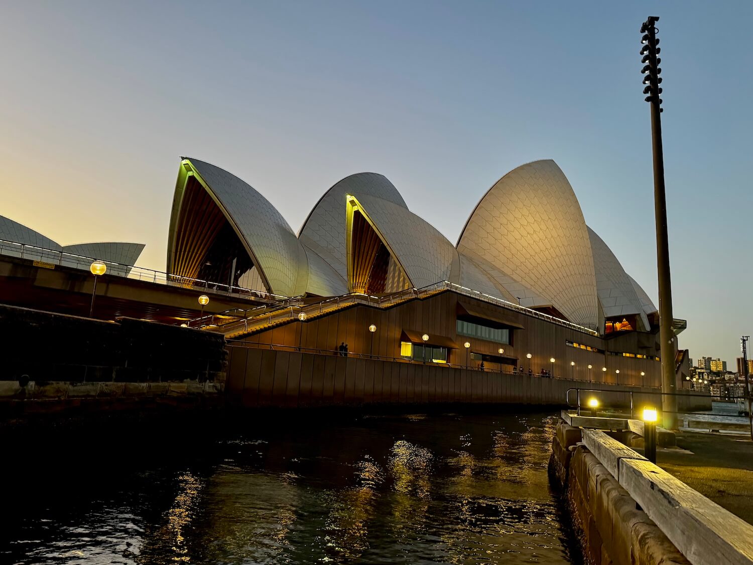 Sydney Opera House lit up in the evening after sunset